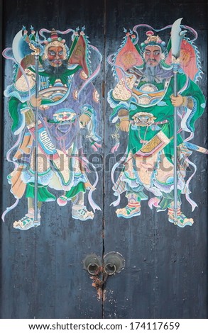 HONG KONG - OCTOBER 2, 2010: Two warriors (door gods) on the gate of Yeung Hay Temple. Intimidating figures protect the temple by scare away evil spirits.