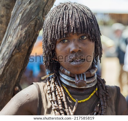 TURMI, OMO VALLEY, ETHIOPIA - DECEMBER 30, 2013: Unidentified Hamar woman seller at village market. Weekly markets are important events in Omo Valley tribal life.