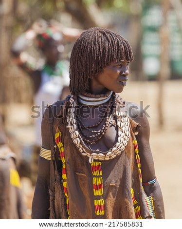 TURMI, OMO VALLEY, ETHIOPIA - DECEMBER 30, 2013: Unidentified Hamar woman at village market. Weekly markets are important events in Omo Valley tribal life.