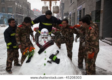 BEIJING - JANUARY 03: The biggest snowfall in 60 years. Fire crew making snowmen in Qianmen Dajie. January 03, 2010 in Beijing, China.