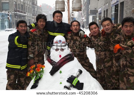 BEIJING - JANUARY 03: The biggest snowfall in 60 years. Fire crew making snowmen in Qianmen Dajie. January 03, 2010 in Beijing, China.