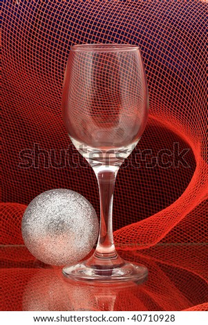 glass of  and a Christmas decoration on a red background network