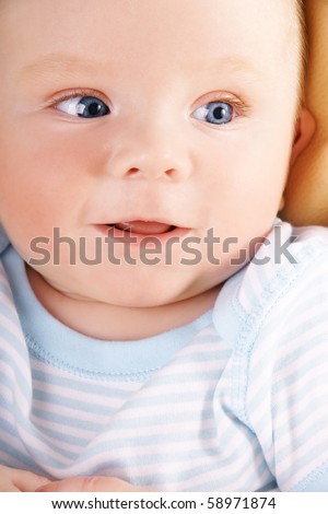 Portrait of pretty happy blue-eyed smiling baby-boy, studio shot