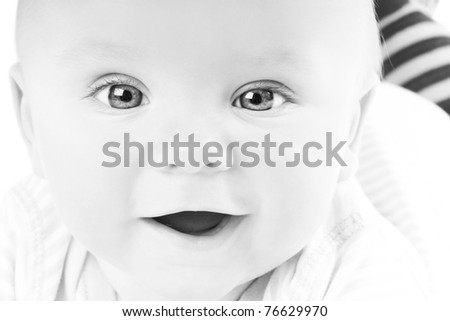 Portrait of cute happy little smiling baby in studio, black&white style