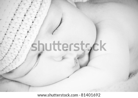 Close-up portrait of newborn cute sleeping baby boy, studio shot