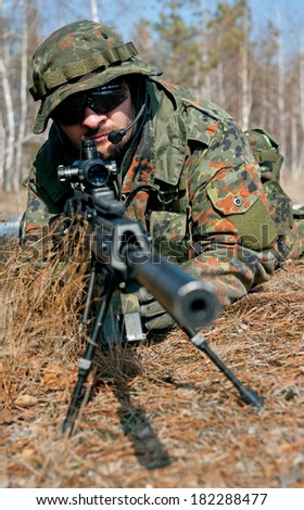 Masked sniper is aiming at the target during the mission