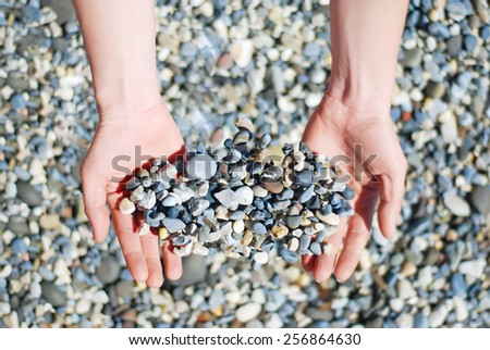 Abstract and Objects. Many small stones in hands