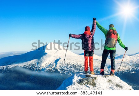Two tourists reaching the summit. Active sport concept