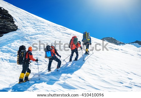 Goup of climbers reaching the simmit. Team work concept