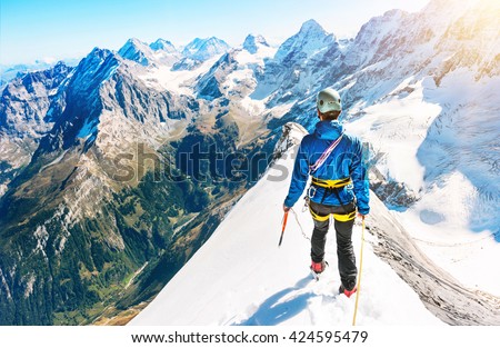 A climber reaching the summit of the mountain