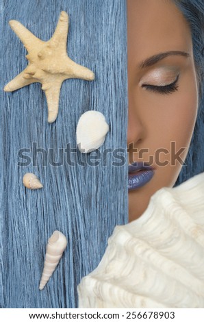 young woman with straight blue hair, shells, closed eyes