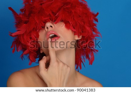 sexy woman with red feathers on blue background