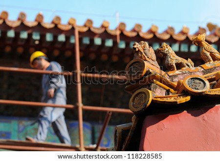BEIJING - NOV 6: a worker (blurred on background) during repair work in the Forbidden City on November 6, 2012 in Beijing, China. The repair is part of a 16-year project costing 250 million US dollars