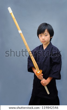 Young Asian boy practicing kendo ( Asian form of martial arts )