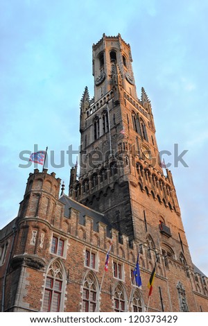 Belfry ( Belfort ) tower of Bruges, Belgium decorated with international flags and flag of the city of Bruges.