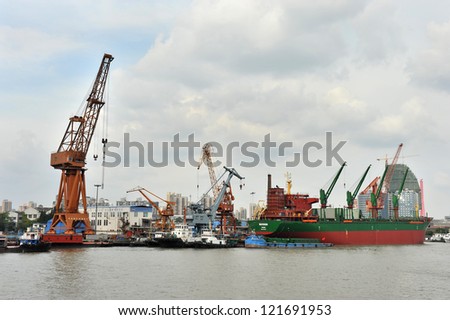 SHANGHAI - APRIL 5: Docks at Shanghai harbor on April 5, 2012 in Shanghai, China. From 2010, Shanghai became the world\'s busiest container port, handling over 30 million TEUs - a historic record.