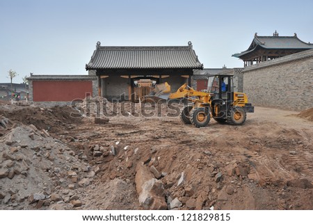 BEIJING - JUNE 9: work activity at a construction site on June 9, 2012 in Beijing, China. More and more buildings are rapidly built in China\'s big cities and becoming unpayable for many people.