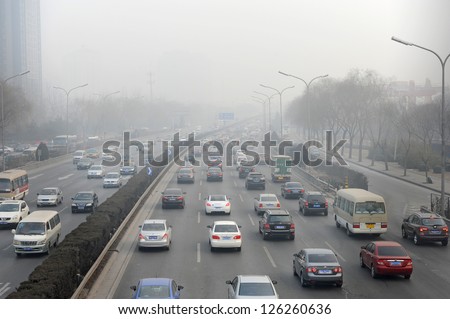 BEIJING - JAN 12: traffic jam and severe pollution on January 12, 2013 in Beijing, China.   Air quality index levels were classed as \