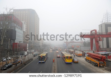 BEIJING - FEB 28:  Traffic scene with severe air pollution on February 28, 2013 in Beijing, China. Air quality index levels were classed as Beyond Index (PM 2.5 of over 700 micrograms per cubic meter)