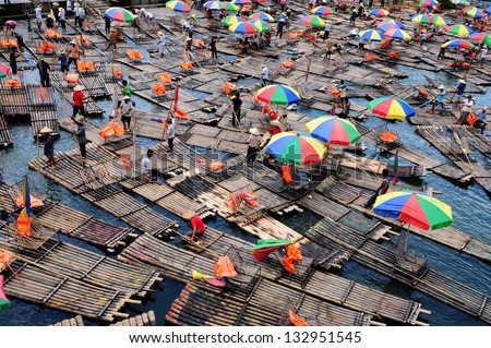 GUILIN - OCTOBER 1: Bamboo rafts on the Li river during national holiday on October 1, 2010 in Guilin, China. During this holiday period around 80.000 people visit the Guilin area daily.