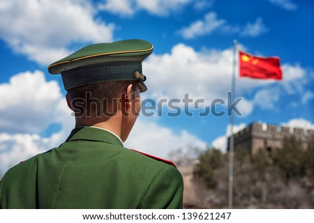 BEIJING - APRIL 24: Soldier stands guard near the Great Wall of China during a high profile visit by a French government delegation on April 24, 2013 in Beijing, China.