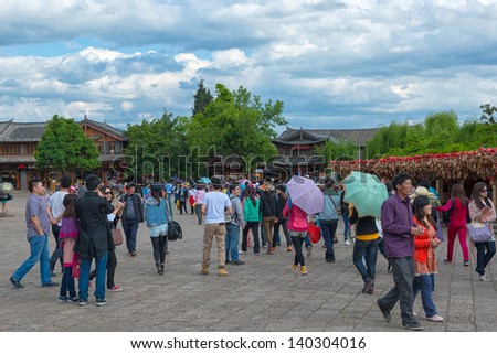 LIJIANG - OCT 3: crowd of people travel during national holiday on October 3, 2012 in Lijiang, China. More than 20.000 people visit sites like Lijiang Old Town daily.
