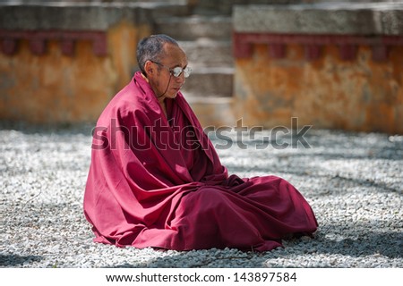LHASA - MAY 2: Unidentified monk engaged in meditation at Drepung monastery on May 2, 2013 in Lhasa, Tibet. Meditation is part of the monastery curriculum to become a higher lama.