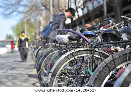 BEIJING - MAY 9: bicycles parked along a street in downtown Beijing on 9 May, 2013. Beijing has over 13 million bicycles in 2013 and has the largest number of bicycles in the world.
