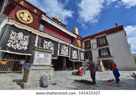 LHASA - APRIL 30: Tibetan worshippers from all over Tibet pray in front of their holiest temple, the Jokhang on April 30, 2013 in Lhasa, Tibet.