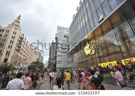 Shanghai - Aug 22: People Walking In Front Of Apple Store On Nanjing Road On August 22, 2013 In Shanghai, China.This Store Is One Of Several Stand-Alone Flagship Apple Stores In High-Profile Locations