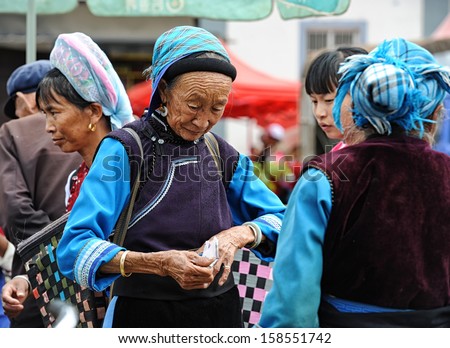 DALI, CHINA - OCTOBER 5: Chinese minority people trading on the week market on October 5, 2013 in Dali, China. Many people depend on selling their products here and only make around $800 a year.