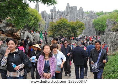 KUNMING, CHINA - OCT 1: crowd of people travel during national holiday on October 1, 2012 in Kunming, China. More than 20.000 people visit sites like the Kunming Stone Forest daily.