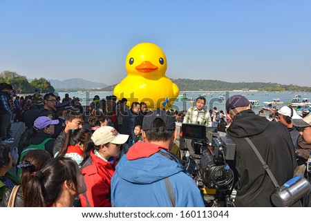 BEIJING - OCTOBER 26: The famous rubber duck designed by Dutch artist Florentijn Hofman is exhibited at the Summer Palace on October 26, 2013 in Beijing, China. The giant duck is 18 meters high.