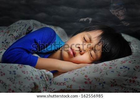 Boy having a scary dream (witch in dark clouds hanging above the boy)