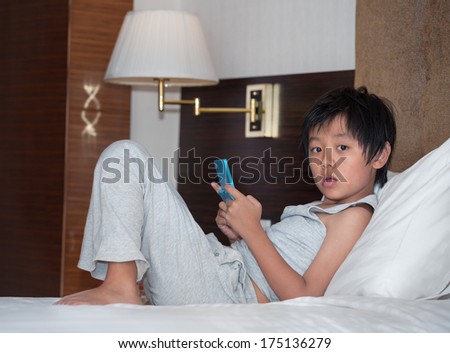 Asian boy caught while playing on computer game machine
