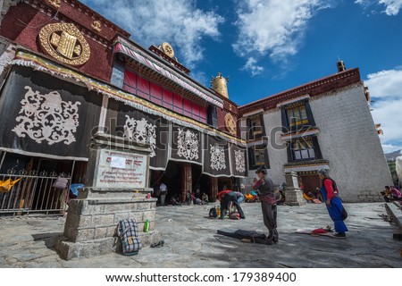 LHASA - APRIL 30: Tibetan worshippers pray in front of their holiest temple, the Jokhang on April 30, 2013 in Lhasa, Tibet.