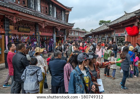 LIJIANG - OCT 3: crowd of people travel during national holiday on October 3, 2012 in Lijiang, China. More than 20.000 people visit sites like Lijiang Old Town daily.