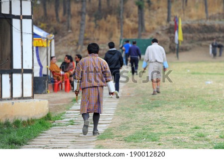 THIMPHU, BHUTAN - April 5: Bhutanese participants walk to their starting position during an archery competition on April 5, 2014 in Thimphu, Bhutan. Archery is the national sport of Bhutan.