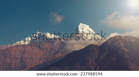 Panorama of beautiful Himalayan mountains after sunrise (sun-effect on upper right corner)