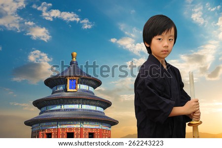 Young martial arts master in front of Asian temple