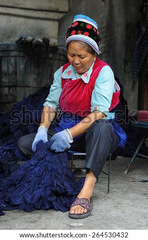 DALI, CHINA - JULY 22: Unidentified woman of Chinese Bai ethnic minority making batik (textile dyeing) on July 22, 2011 in Dali, China. These people depend on batik as a way to make a living.