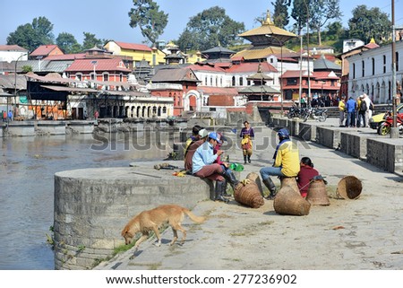 KATHMANDU - NOV 11: Nepali workers rest at Pashupatinath temple cremation site on November 11, 2014 in Kathmandu, Nepal. Pashupatinath temple is considered the holiest Hindu temple in Nepal.