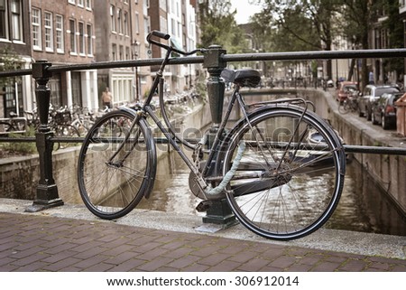 Bicycle on a bridge over the canals of Amsterdam