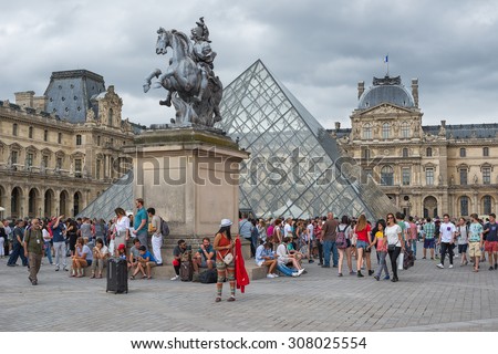 PARIS - JULY 21: Tourists visit the Louvre Museum on July 21, 2015 in Paris, France. In year 2014 more than 15 million tourists visited the city of Paris.