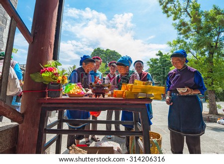 DALI, CHINA - May 9:Bai ethnic minority people making offerings in front of a temple on May 9, 2014 in Dali,China. Bai people belong to one of the 56 ethnic groups recognized by the Chinese government