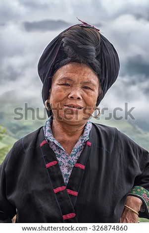 LONGJI, CHINA - SEPTEMBER 27: Yao woman in traditionall clothes poses for a photo during Longji festival on September 27, 2015 in Longji, China. The Yao people are an ethnic group of Southeast Asia.