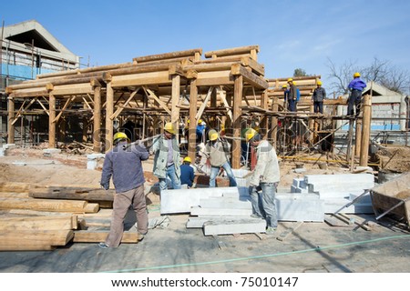 BEIJING - APRIL 16: work activities at a construction site on April 16, 2010 in Beijing, China. New houses are continuously built in China\'s big cities.