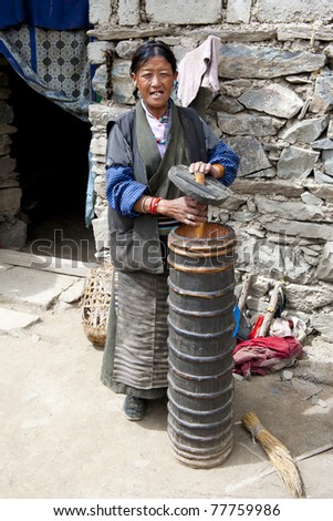 SHIGATSE - MAY 10: Tibetan farmer producing traditional yak butter tea on May 10, 2010 in Shigatse, Tibet. For this farmer butter tea is the main source of income (around $800 annual).