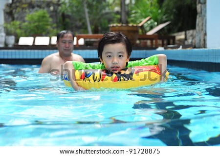 Grandfather teaching grandchild to swim