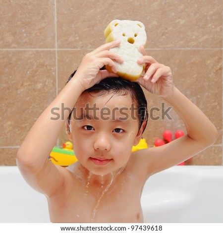 Cute Asian boy having bath